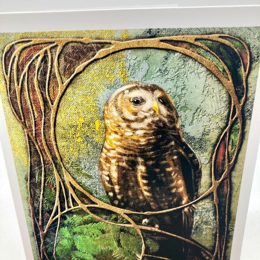 A close-up of a textured art print featuring a brown and cream owl framed by organic, vine-like brown borders on a muted green and yellow background.