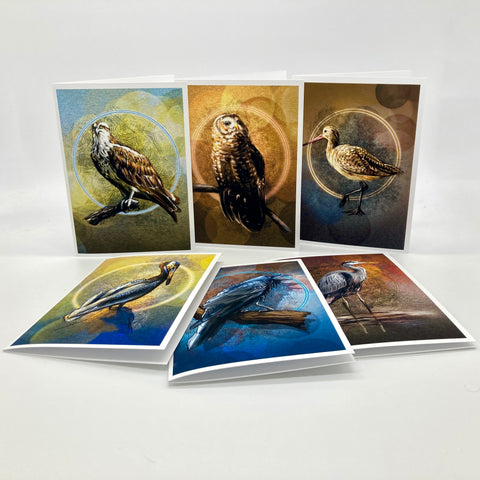 A set of bird-themed art cards displayed on a white surface, showing both upright and angled views of cards featuring painted birds including an osprey, owl, sandpiper, and others.