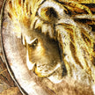 Close-up of a lion's head with a detailed background