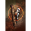 Woodpecker perched on a branch with a warm, circular glow in the background