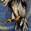 Close-up of a detailed illustration of a bird with yellow talons on a blue background