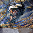 Abstract artwork with gold and blue elements on a textured background