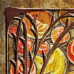 Art Nouveau-style design with stylized leaves and circular patterns in brown, orange, and yellow on a textured background.