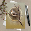 Greeting card with a bird illustration on a branch, surrounded by berries and a pen.