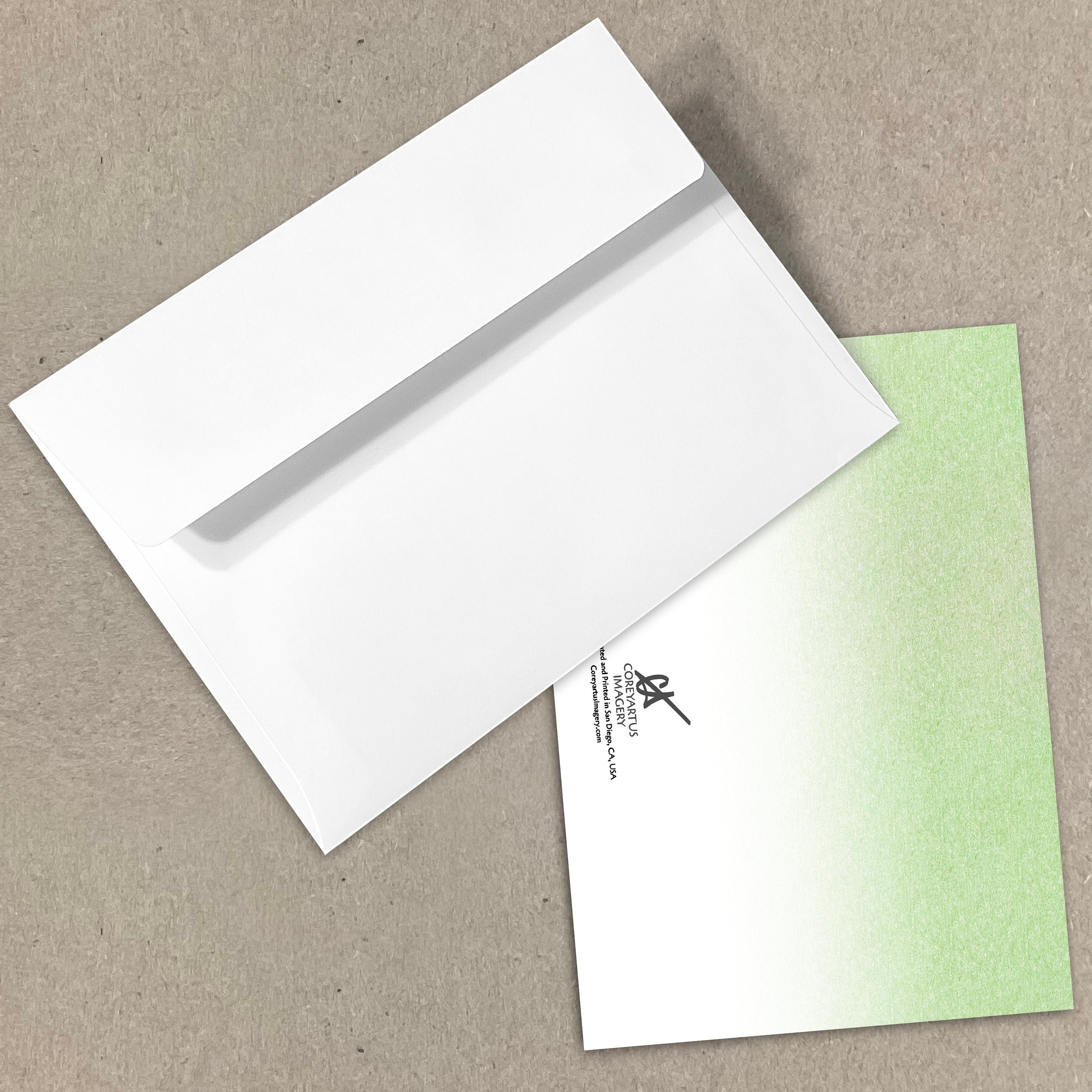 White envelope with a green card on a beige background