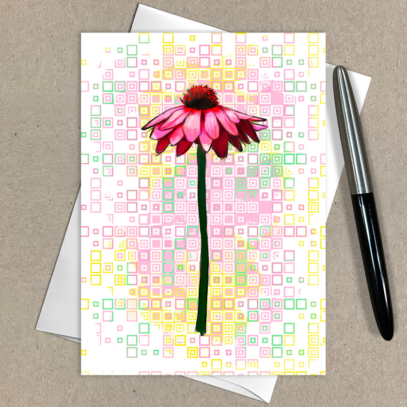 Greeting card with pink flower design on a patterned background, accompanied by a pen.