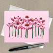 Card with pink floral design on a beige background
