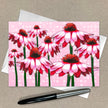 Card with pink and red flower design on a beige background