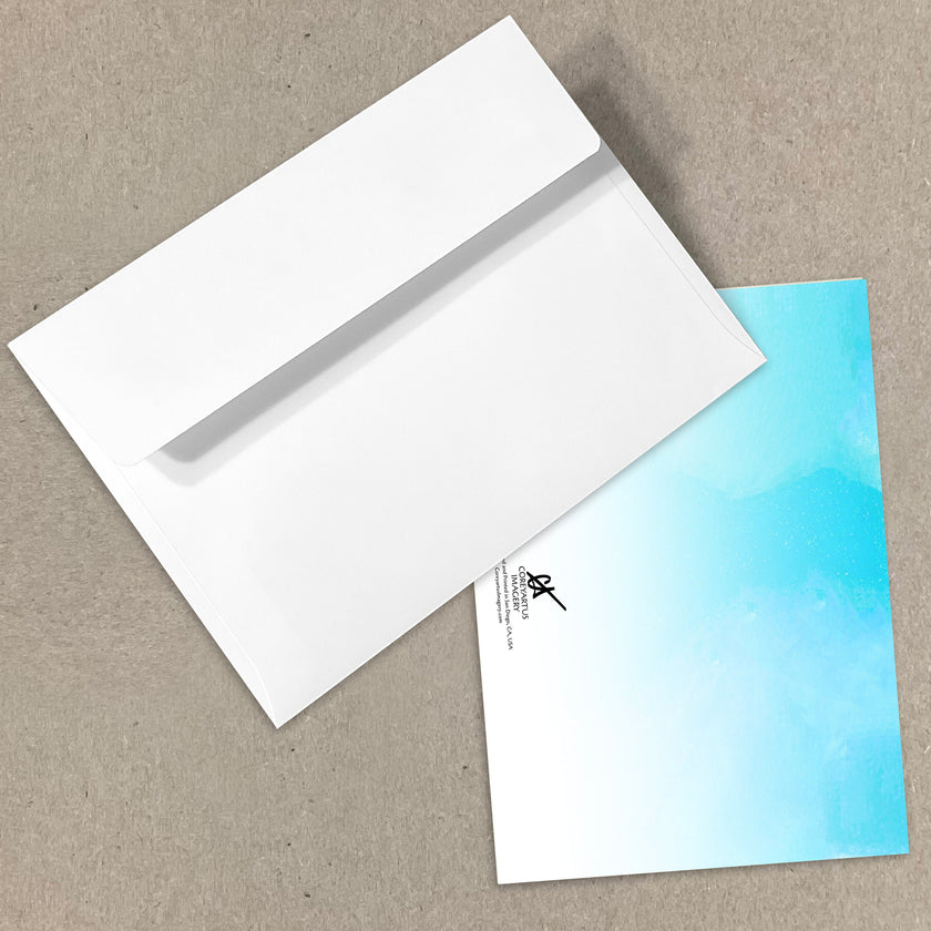 White envelope and blue gradient card on a beige surface
