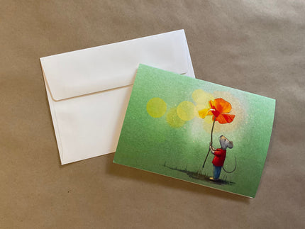 Greeting card with a mouse holding a flower and an envelope on a brown background
