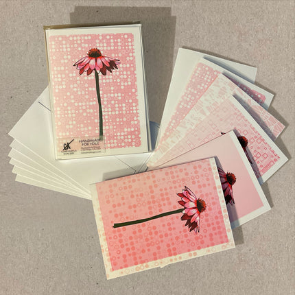 Set of greeting cards with floral design on a textured surface
