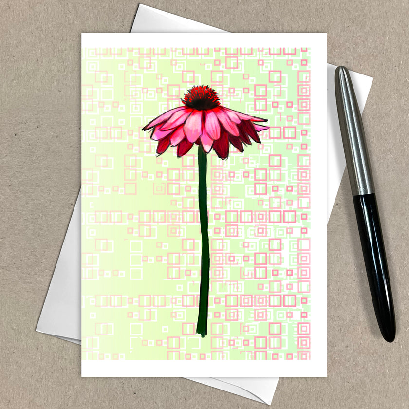 Greeting card with pink flower design on a patterned background, accompanied by an envelope and pen.