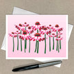 Card with pink floral design on a beige background