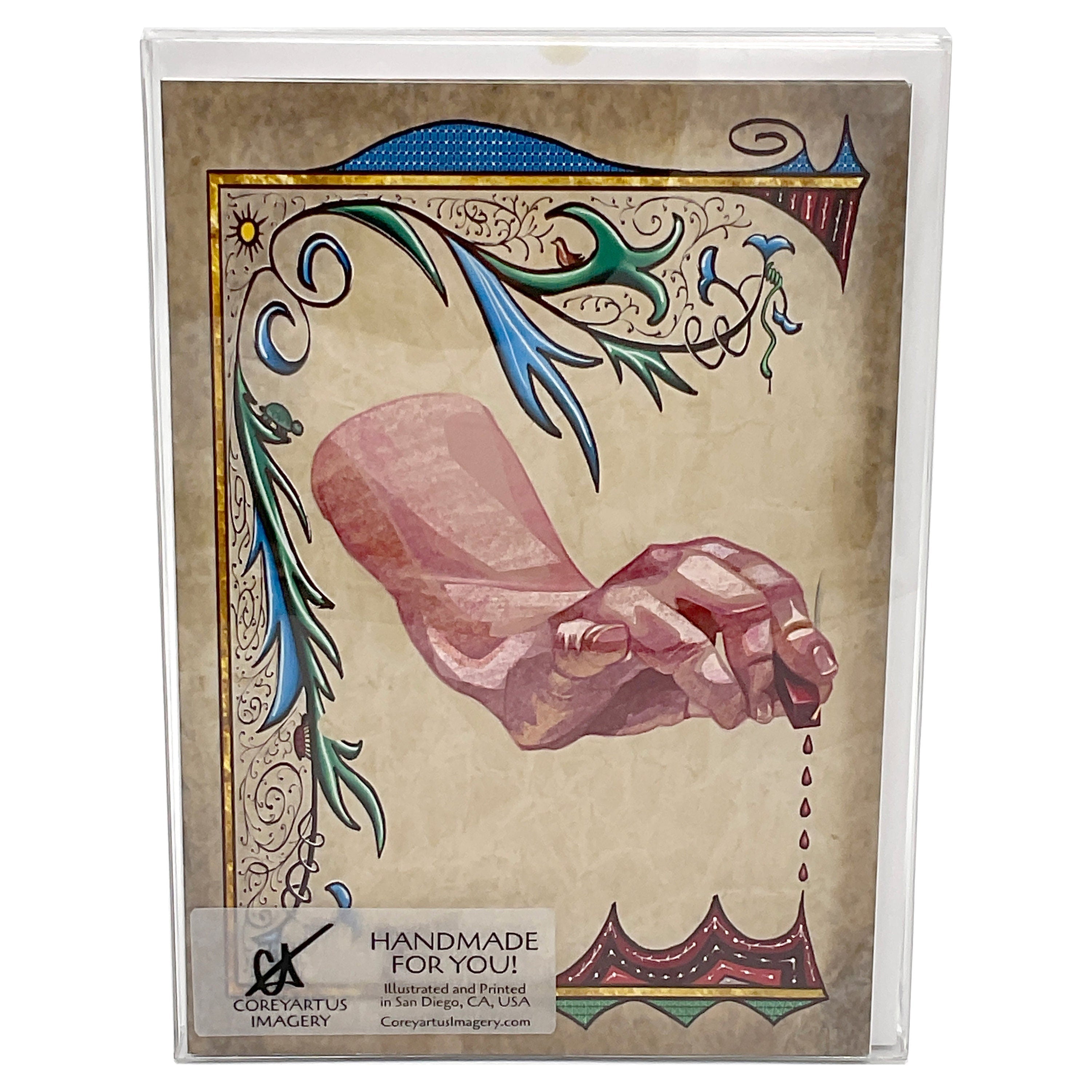 Decorative card with a hand and dripping wax design, packaged in a clear plastic box.