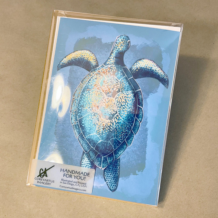 Boxed pack of greeting cards with a blue turtle design on a beige background