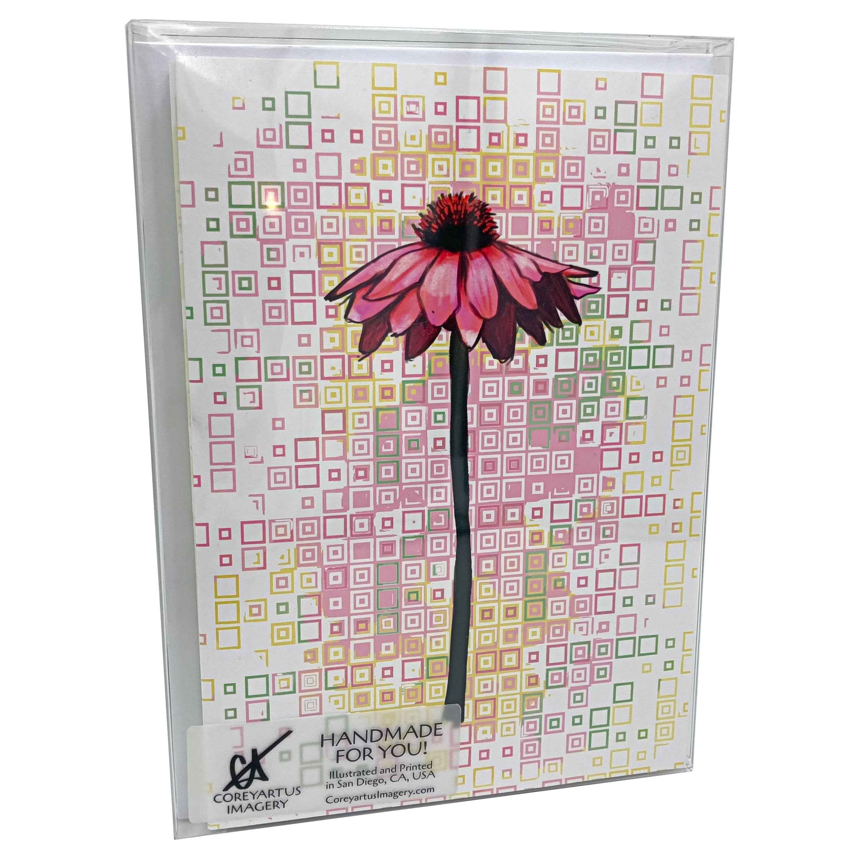 Greeting card with a pink flower design on a patterned background packed in a clear case
