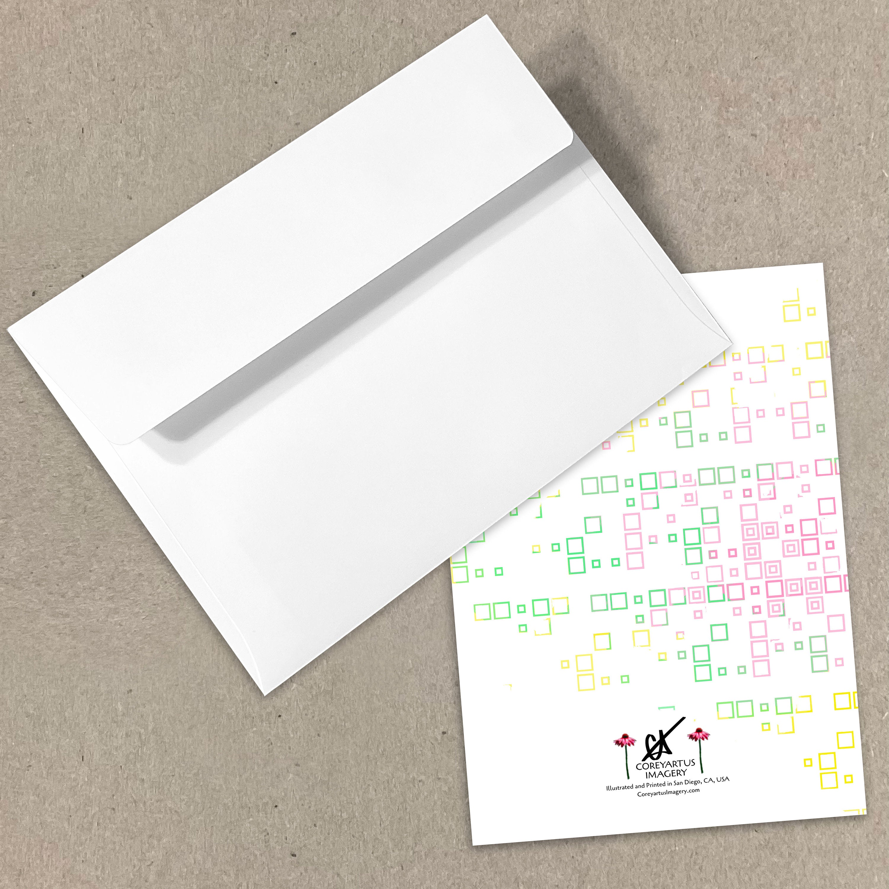 White envelope and card with colorful geometric pattern on a beige background