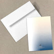 White envelope and gradient card on a beige background