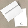 White envelope and card on a beige background