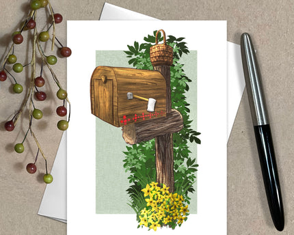 Greeting card with wooden mailbox design, pen, and decorative elements on a textured surface