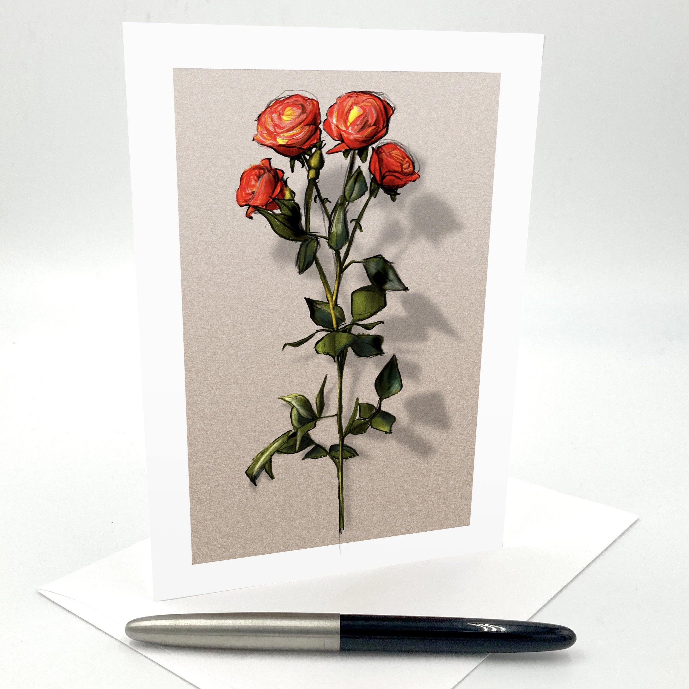 Greeting card with red roses on a beige background, accompanied by a pen.