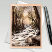 Greeting card with a forest stream design, pen on the side
