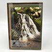 Package of greeting cards with top card featuring a waterfall with trees and greenery on a white background