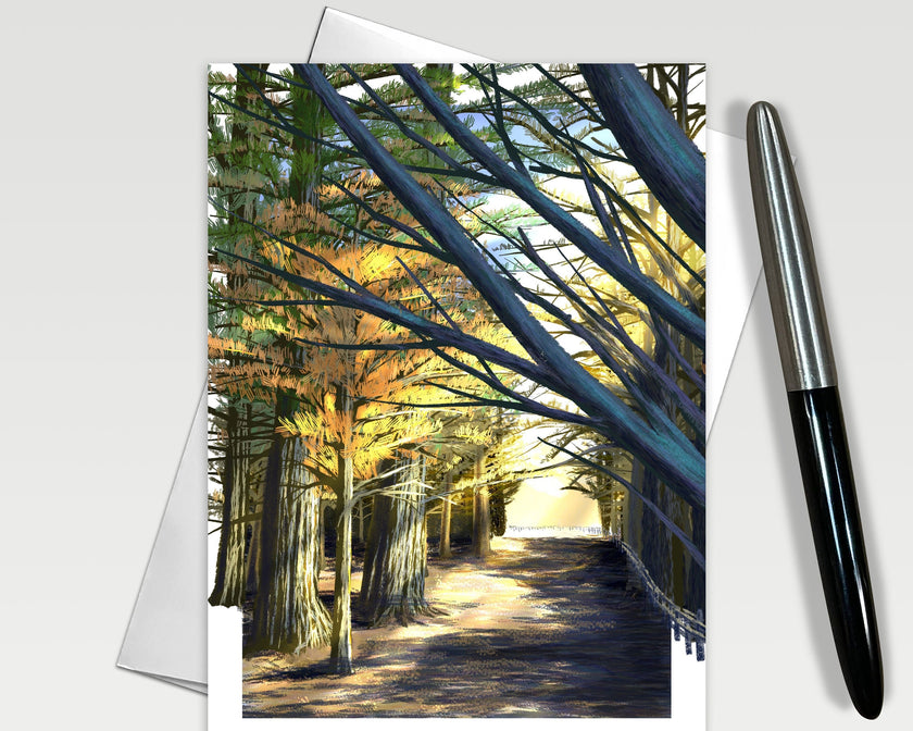 Greeting card with a scenic view of a tree-lined path, pen on the side.