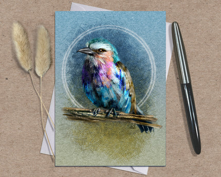 Greeting card with a colorful bird illustration on a textured surface with a pen and dried plants.