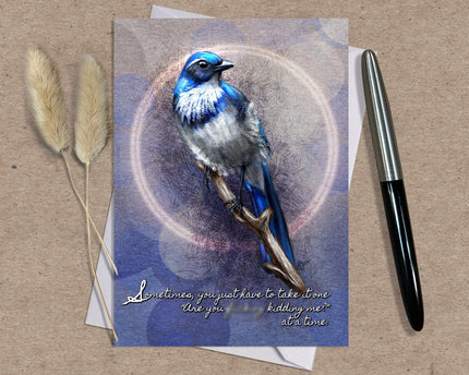 Greeting card with a blue bird illustration and a pen on a textured surface