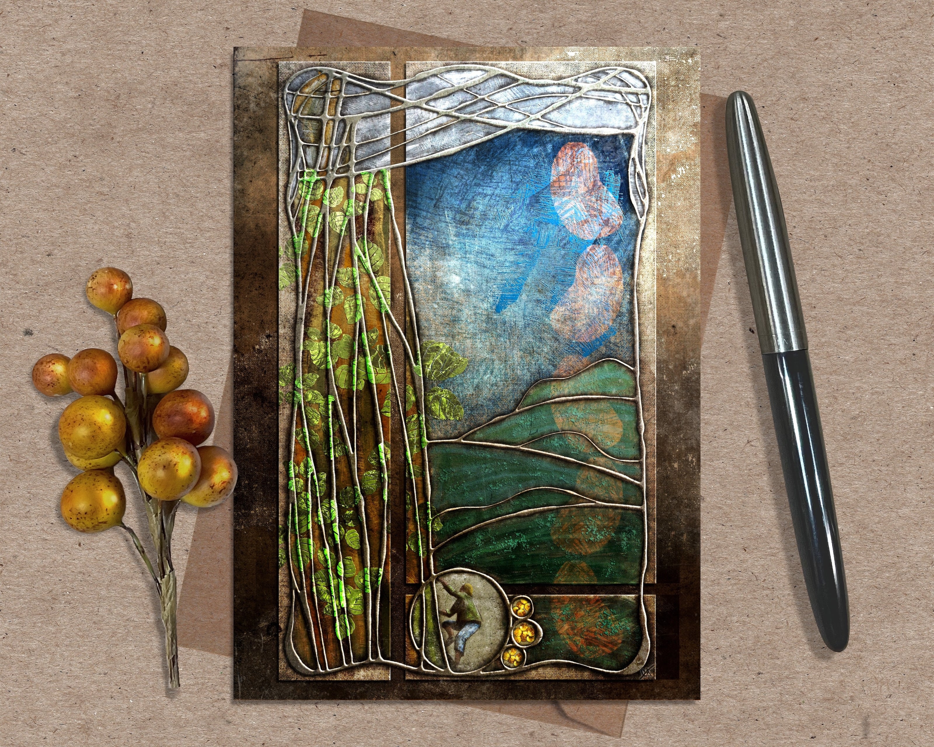 Decorative greeting card with nature-themed design on a textured surface with a pen and decorative branch.