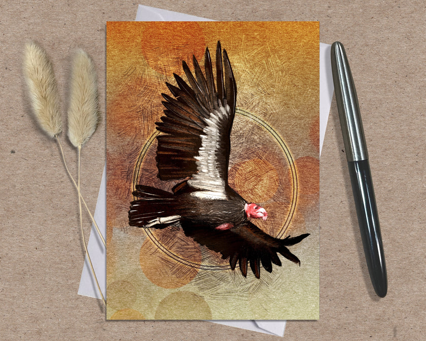 Greeting card with a bird design on a textured surface with a pen and dried plants.