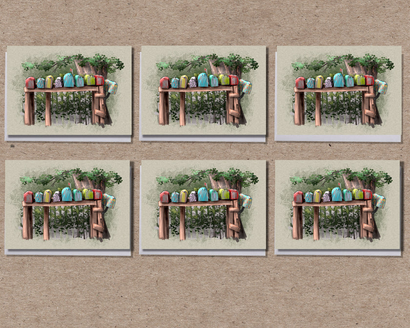 Set of six greeting cards with a wooden bench and colorful birds design on a textured brown background.