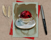 Card with a teacup and red bell on a textured surface with a pen and dried plants.