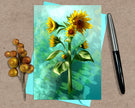 Greeting card with sunflower design on a textured surface with a pen and decorative elements.