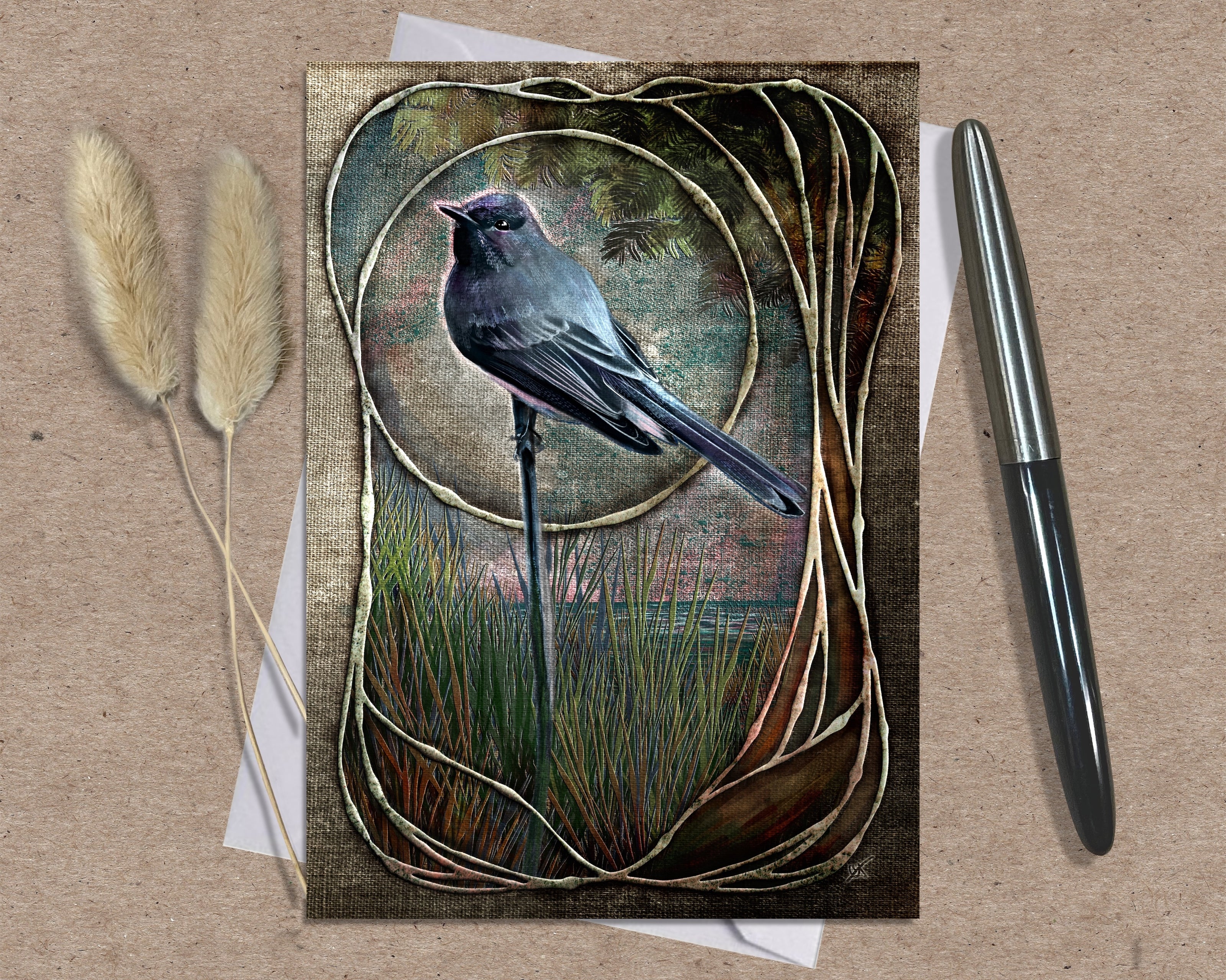 Greeting card with a bird illustration on a textured surface with a pen and dried plants.
