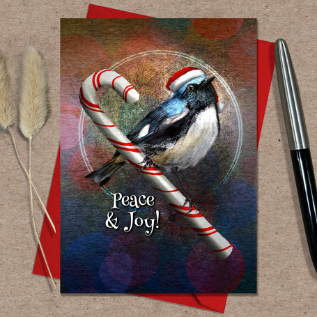 Christmas card with a bird holding a candy cane, featuring 'Peace & Joy!' text, on a red envelope with a pen and decorative elements.