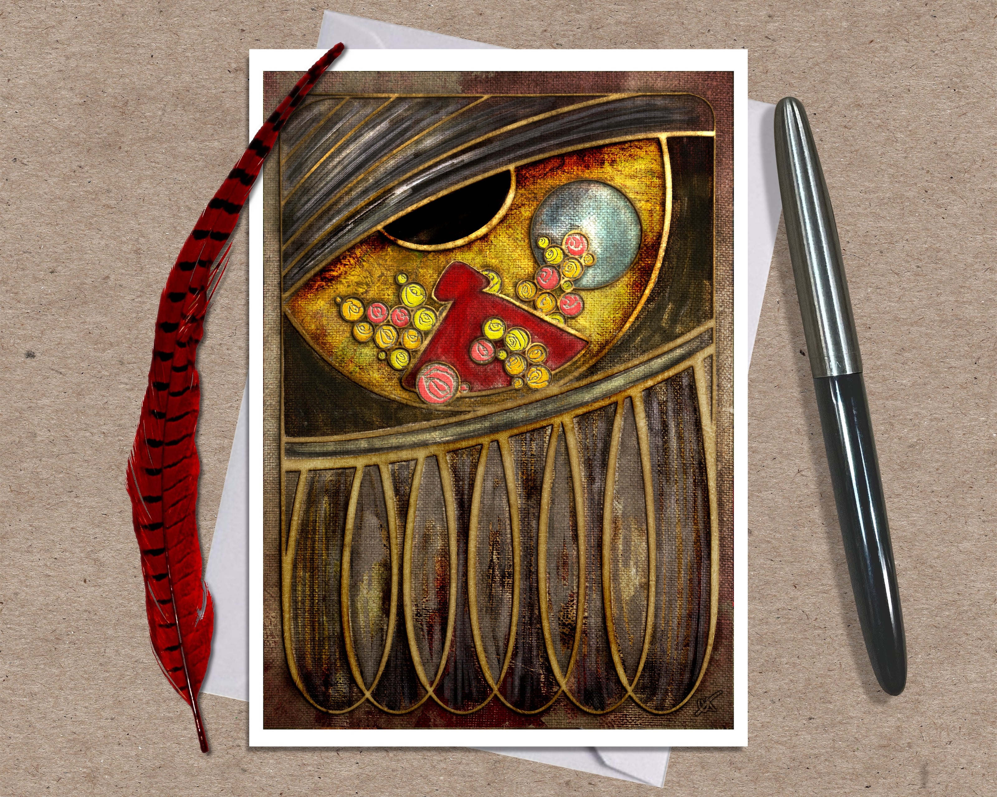 Greeting card with artistic design of an eye with the reflection of a person in a red cloak surrounded by flowers, accompanied by a pen and feather on a textured surface.