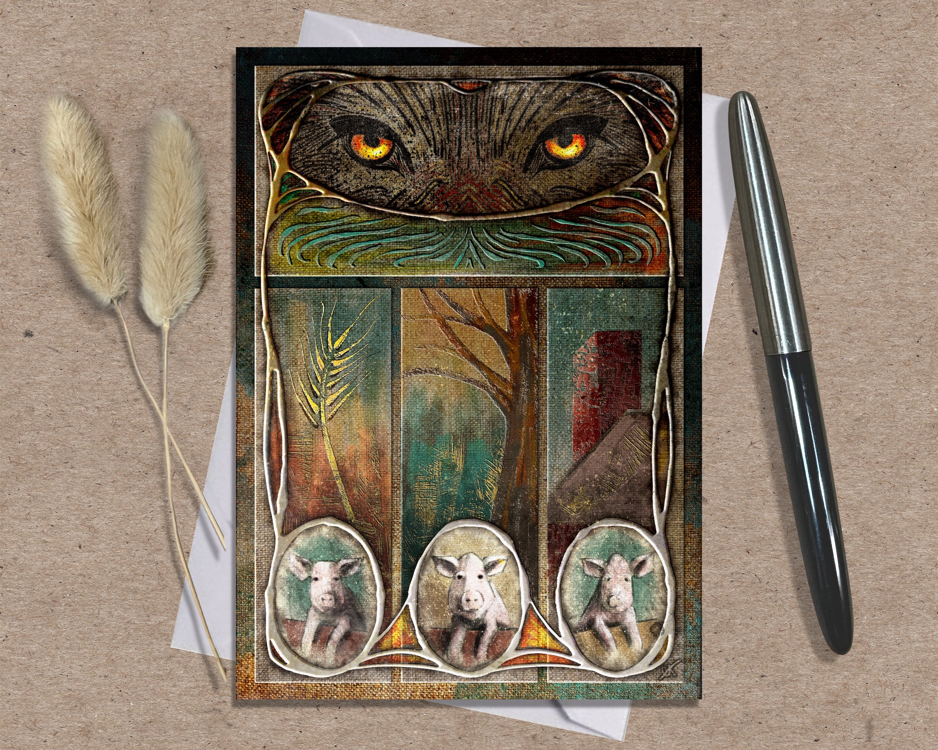 Decorative greeting card with wolf eyes and three small animal portraits on a textured surface with a pen and dried plants.