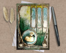 Decorative card with a duck illustration on a textured surface with a pen and dried plants.
