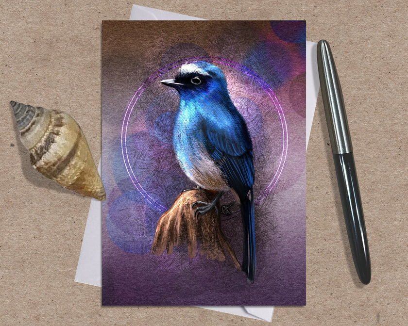 Greeting card with a blue bird illustration on a brown surface with a shell and pen.