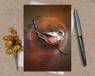 Greeting card with a bird illustration on a brown background, accompanied by a pen and decorative branch.