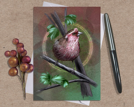 Card with a bird illustration on a branch with leaves and berries, placed on a textured surface with a pen and small plant.