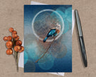 Greeting card with a bird design on a textured surface with a pen and decorative elements.