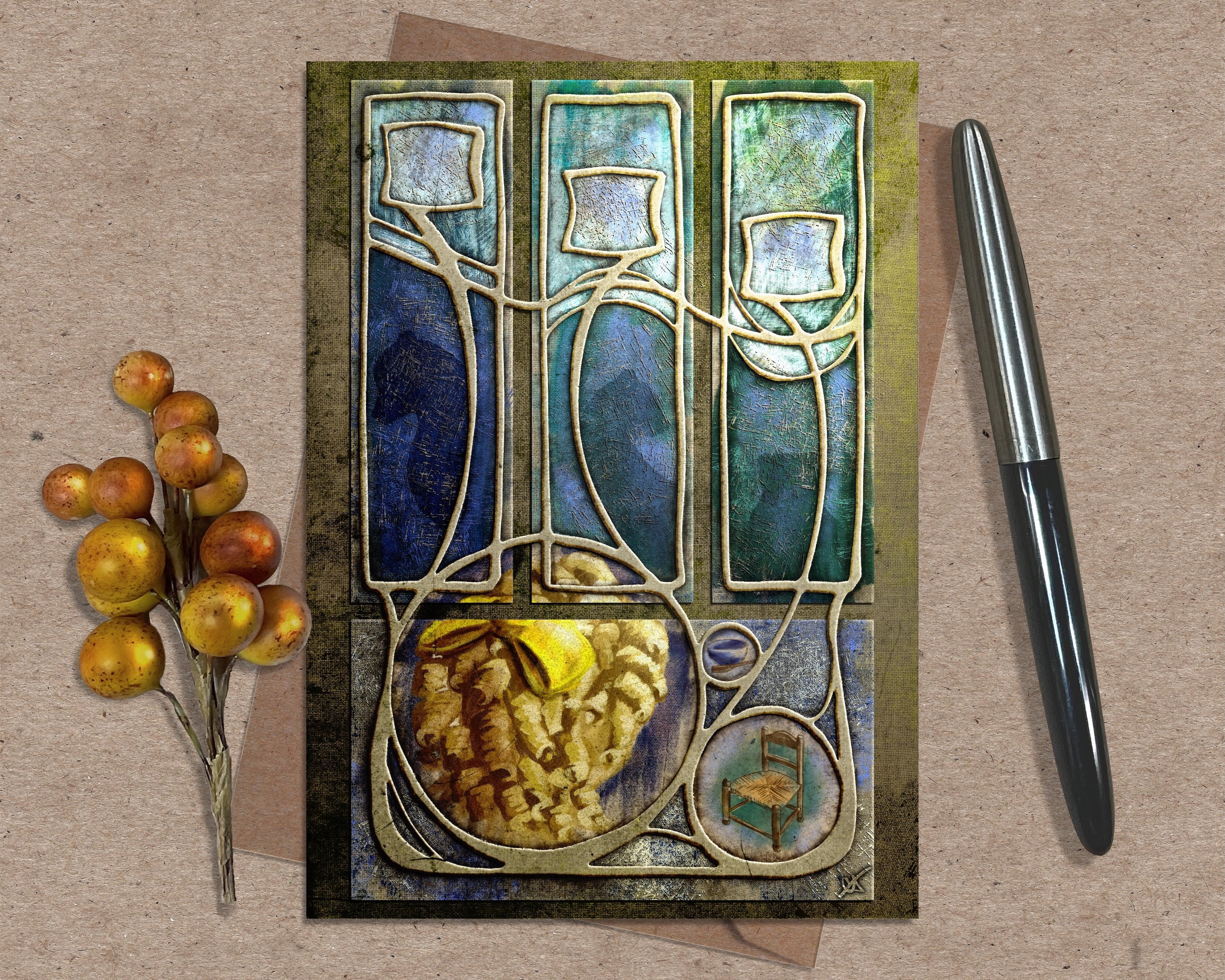 Decorative greeting card with abstract design, pen, and decorative branch on a textured surface