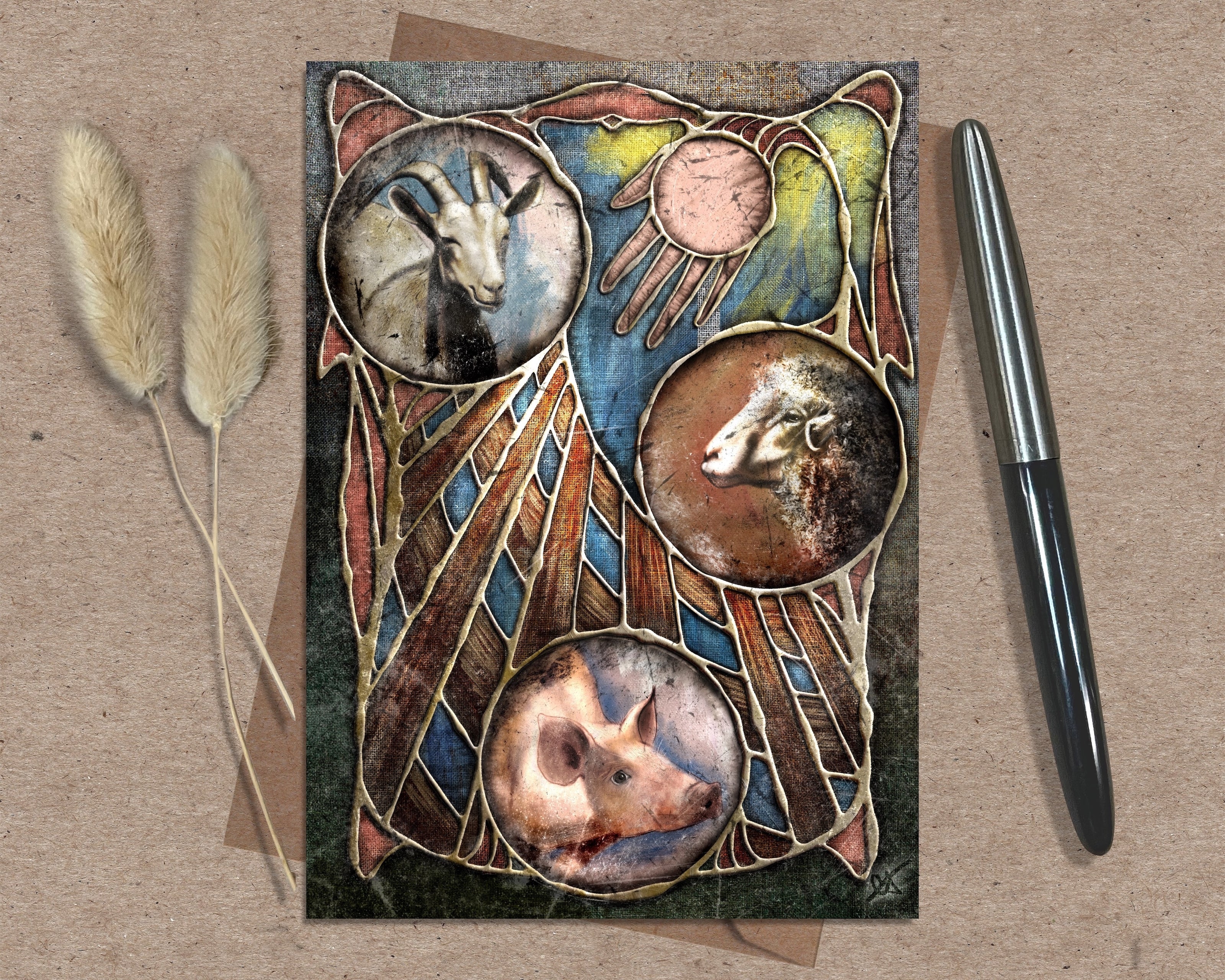 Decorative card with animal illustrations on a textured surface with a pen and dried plants.