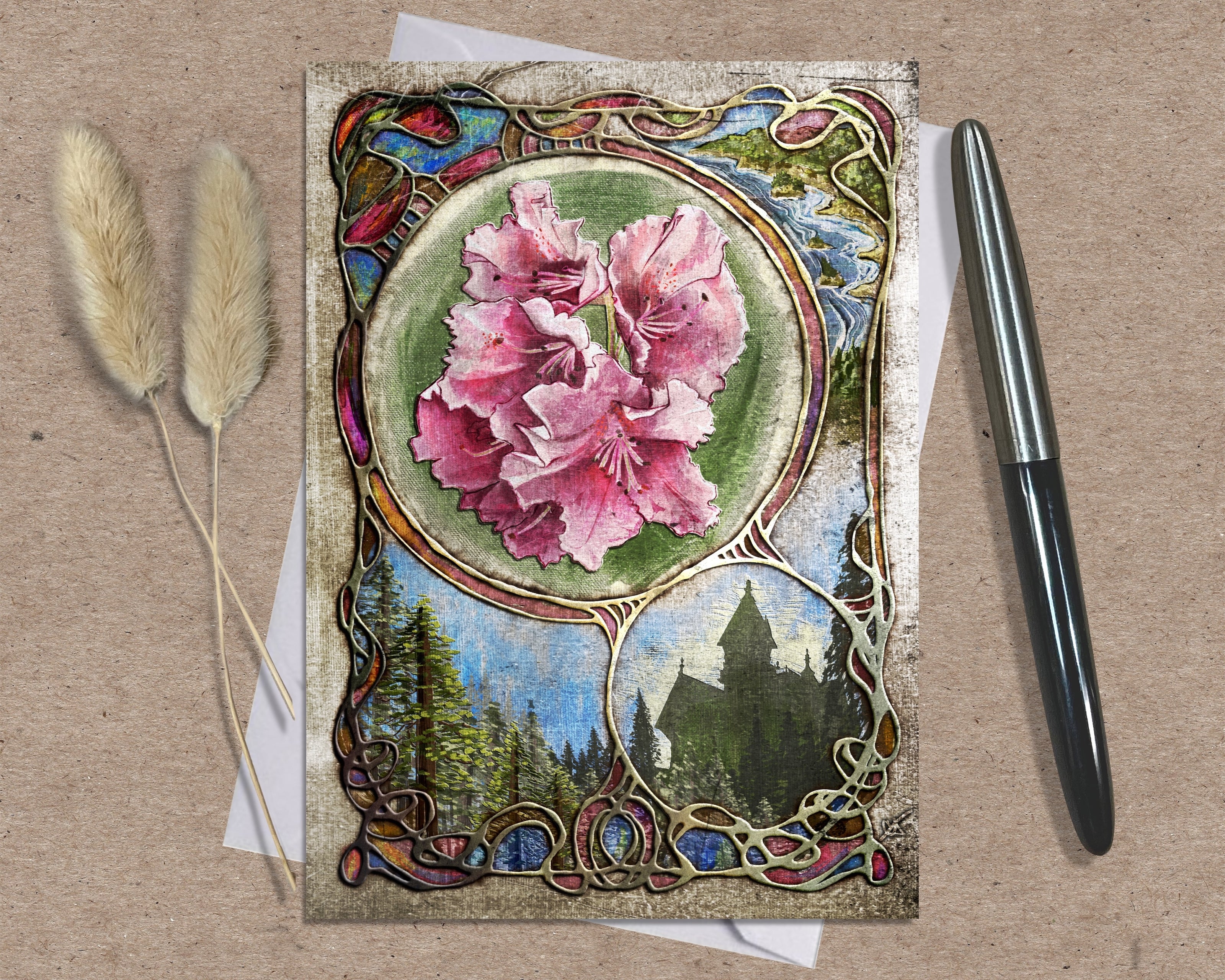 Decorative greeting card with floral design and castle illustration on a textured surface with pen and dried plants.