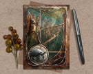 Decorative greeting card with rabbit illustration on a textured surface with a pen and decorative branch.