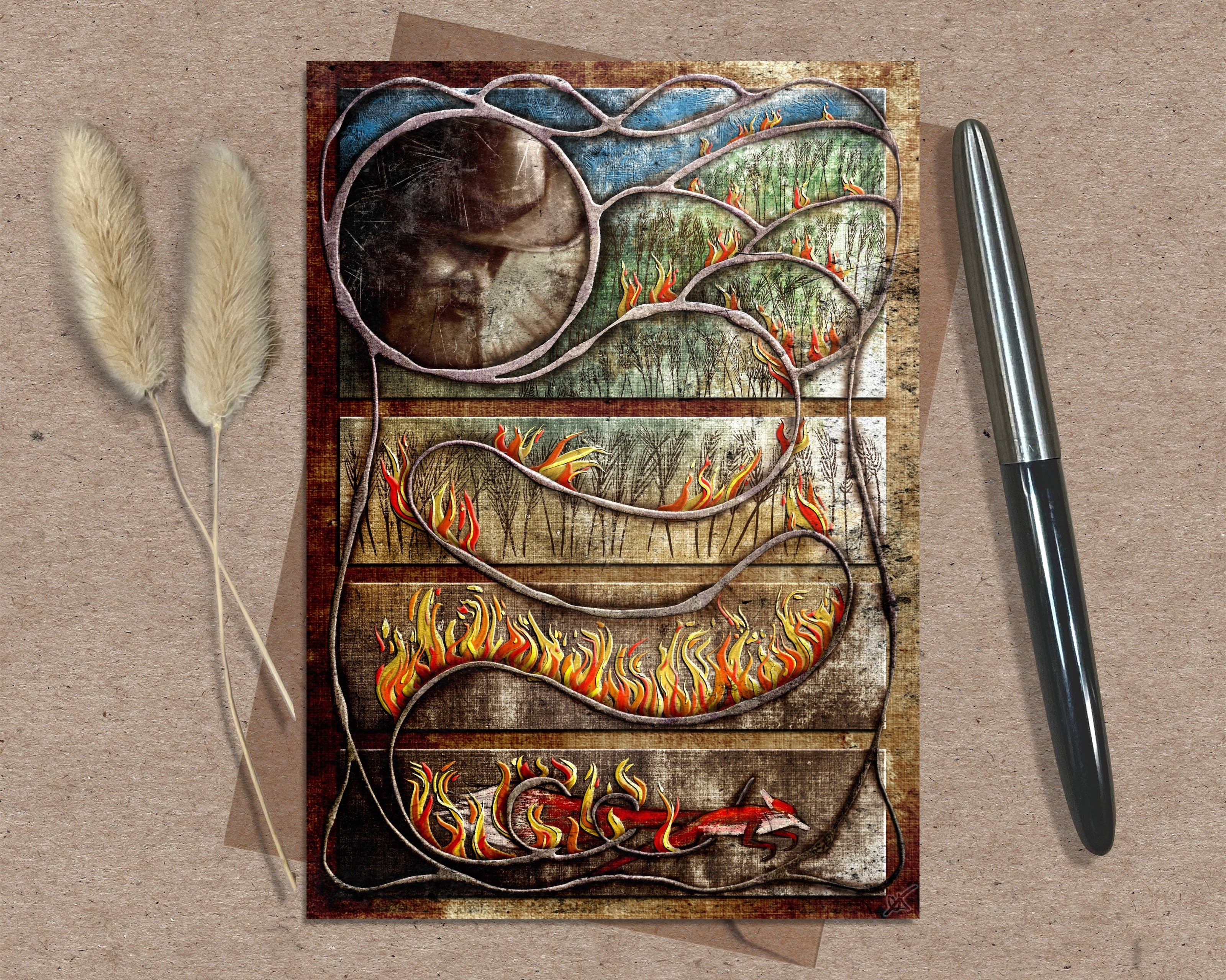 Decorative greeting card with artistic design on a textured surface with a pen and dried plants.