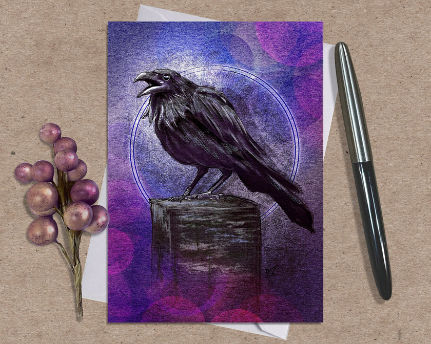 Greeting card with a raven  design on a textured surface with a pen and decorative elements.